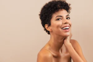 Smiling woman showcasing radiant results after jawline fillers.