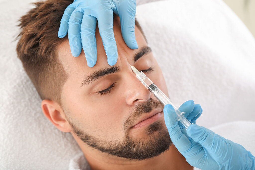 Man receiving injectable treatment between the brows to smooth frown lines.